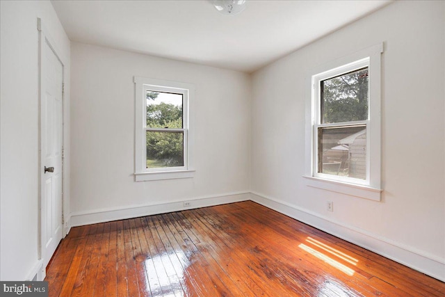 unfurnished bedroom with hardwood / wood-style flooring and baseboards