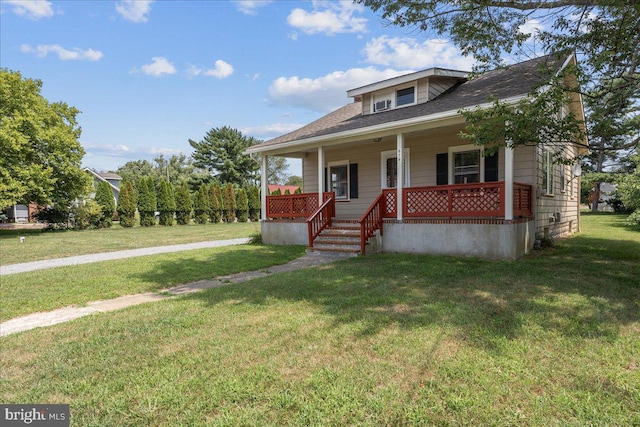 bungalow with covered porch and a front yard