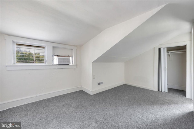 bonus room featuring lofted ceiling, cooling unit, visible vents, baseboards, and carpet