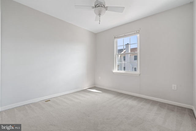 empty room with baseboards, ceiling fan, and carpet flooring