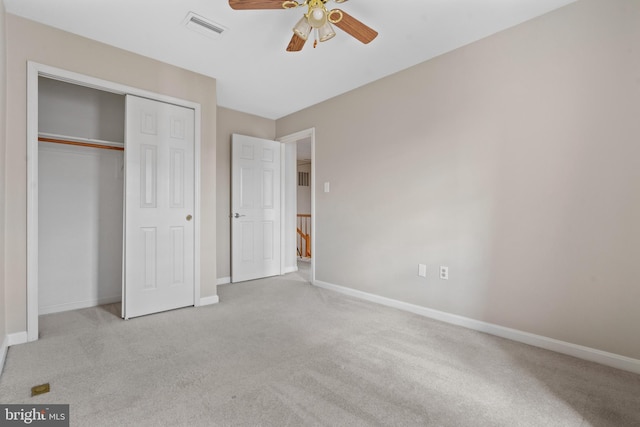 unfurnished bedroom featuring carpet, visible vents, a closet, and baseboards