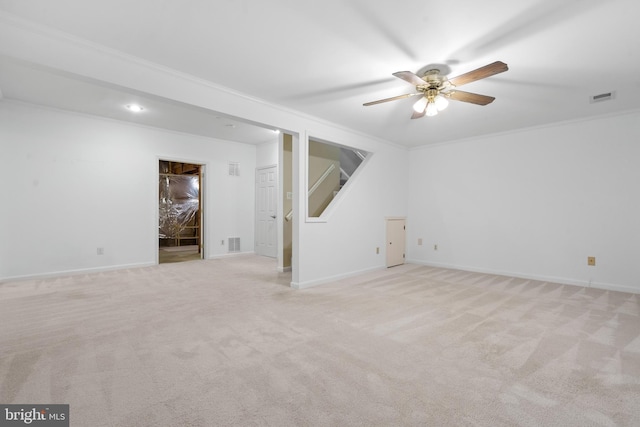 unfurnished room with visible vents, light carpet, and crown molding