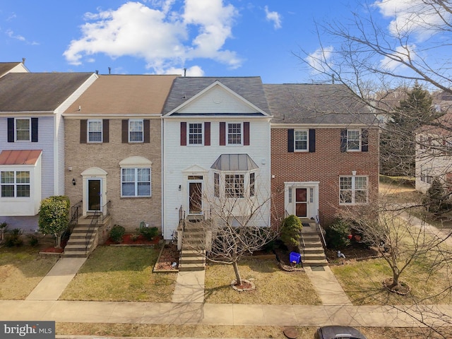 townhome / multi-family property with brick siding