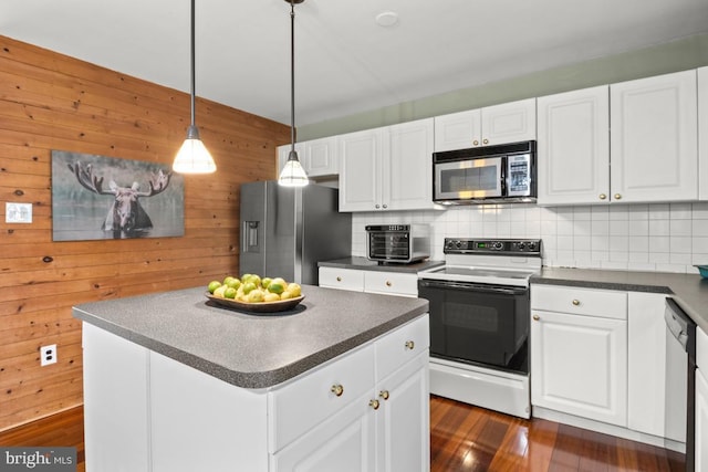 kitchen with dark countertops, decorative backsplash, and appliances with stainless steel finishes