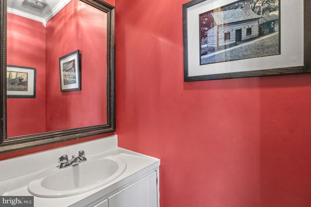 bathroom featuring vanity, visible vents, and ornamental molding