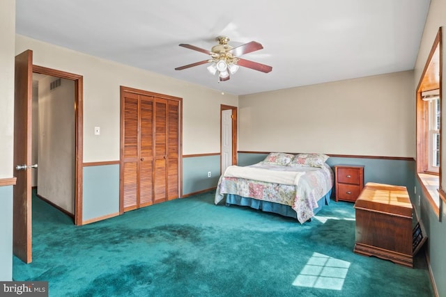 carpeted bedroom with a ceiling fan, visible vents, and a closet