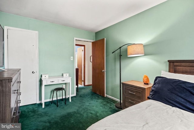 bedroom featuring baseboards and dark colored carpet