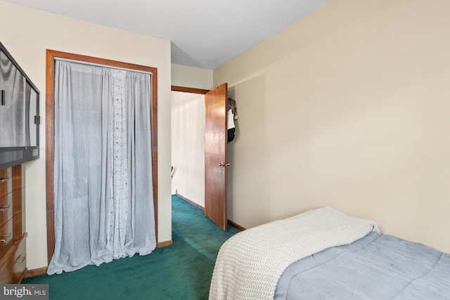 carpeted bedroom featuring baseboards