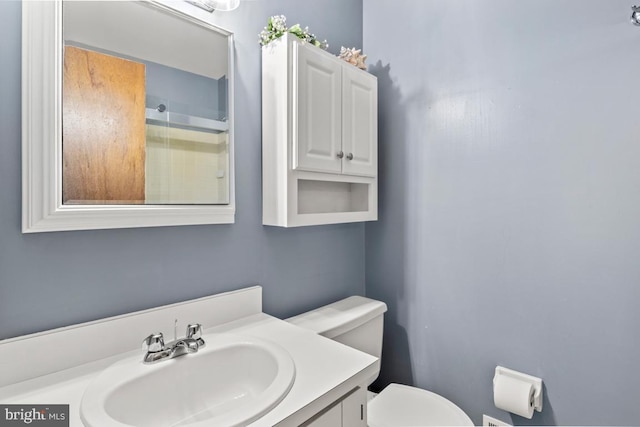 bathroom featuring toilet and vanity