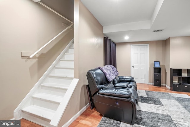 interior space featuring visible vents, baseboards, stairs, recessed lighting, and wood finished floors