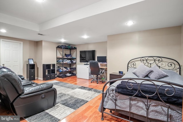 bedroom with recessed lighting, wood finished floors, and visible vents