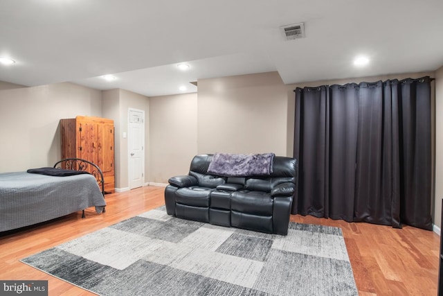 bedroom with visible vents, baseboards, and wood finished floors