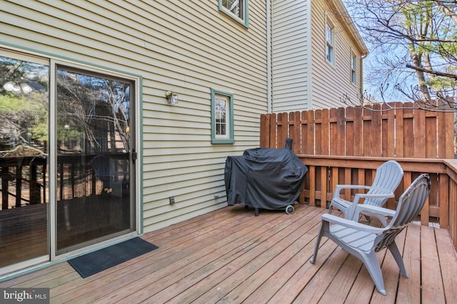 wooden terrace with a grill