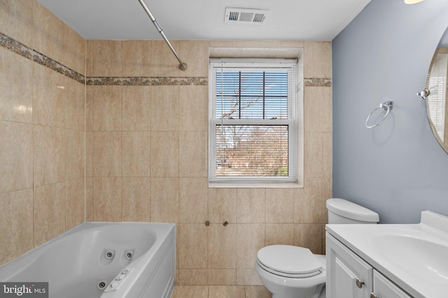 bathroom featuring a healthy amount of sunlight, visible vents, toilet, and vanity