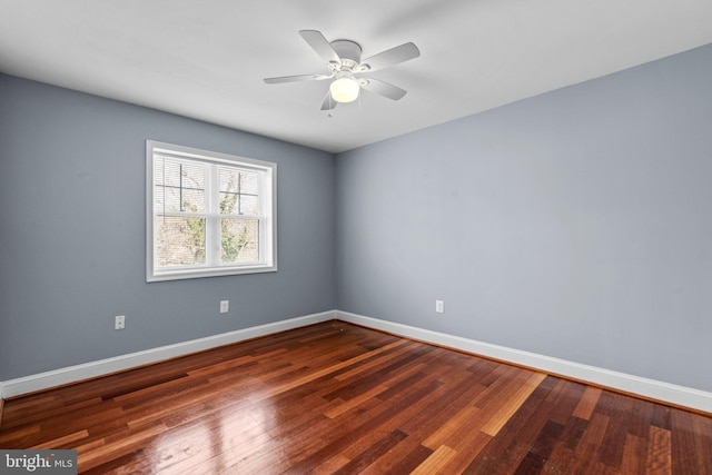 unfurnished room featuring ceiling fan, hardwood / wood-style flooring, and baseboards