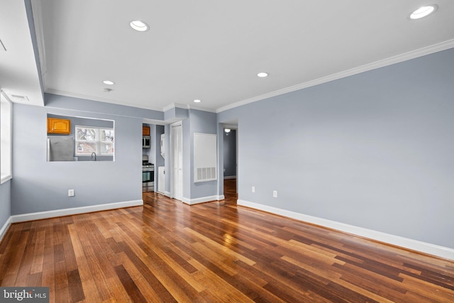 unfurnished room with recessed lighting, visible vents, ornamental molding, baseboards, and hardwood / wood-style flooring