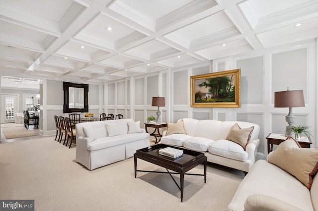 living area with beam ceiling, carpet, and a decorative wall