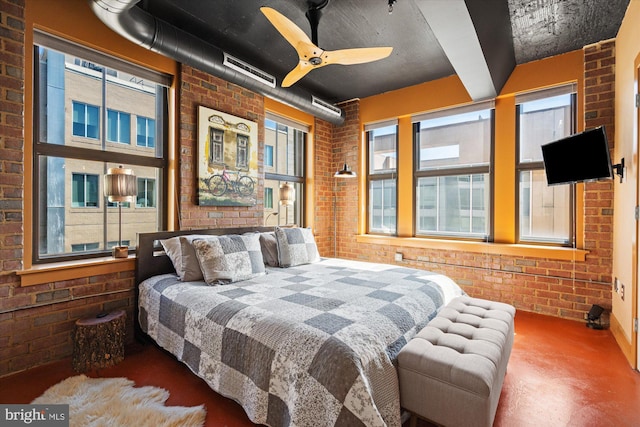 bedroom with concrete floors and brick wall