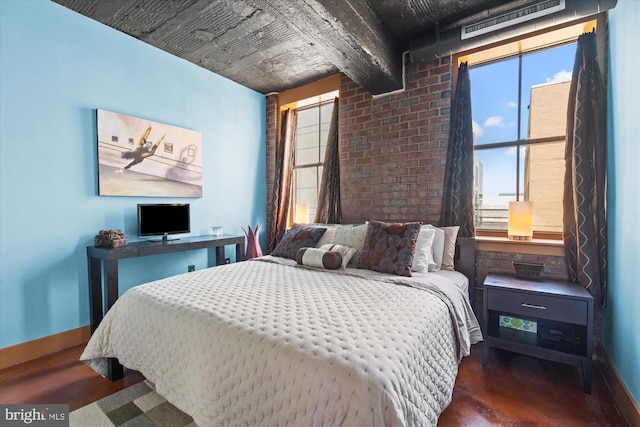 bedroom featuring baseboards and wood finished floors