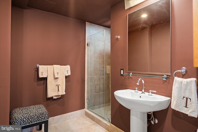 full bathroom featuring tile patterned floors and a stall shower