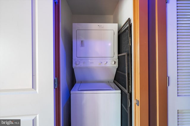 washroom featuring laundry area and stacked washing maching and dryer