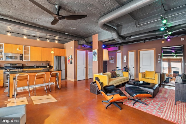 living room with baseboards, concrete floors, and ceiling fan