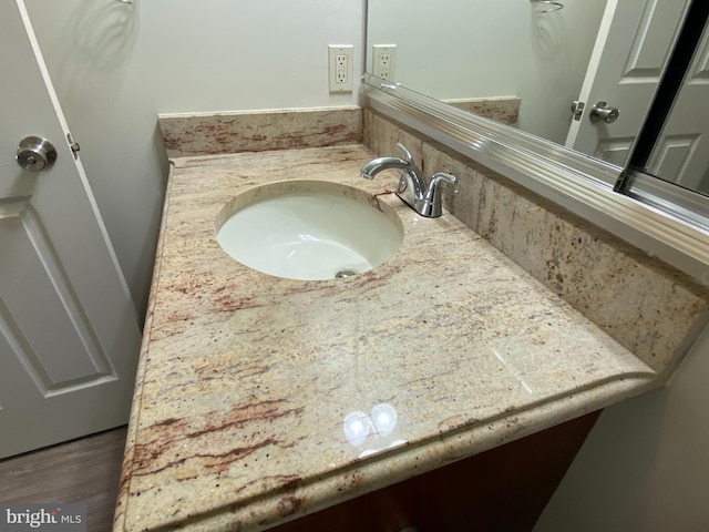 bathroom with vanity and wood finished floors