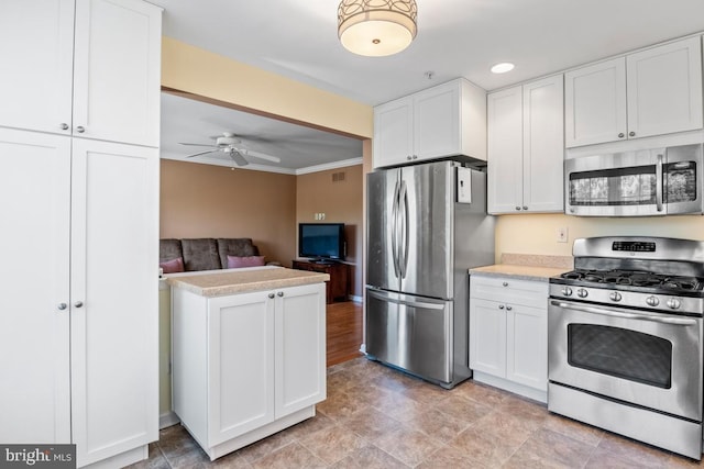 kitchen featuring white cabinets, appliances with stainless steel finishes, light countertops, and a ceiling fan