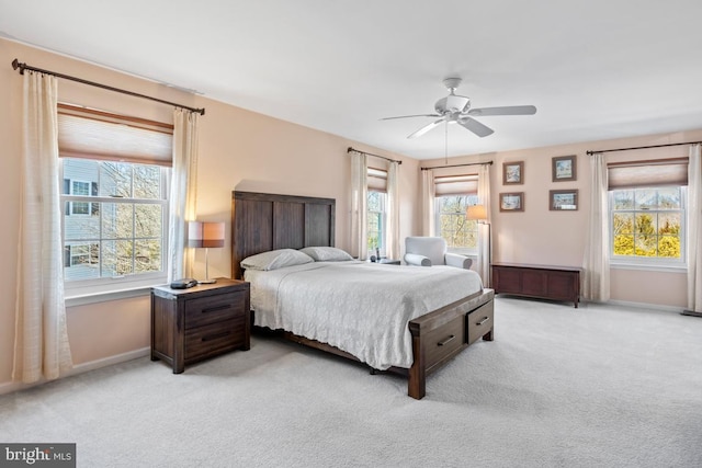 bedroom featuring ceiling fan, baseboards, and light carpet