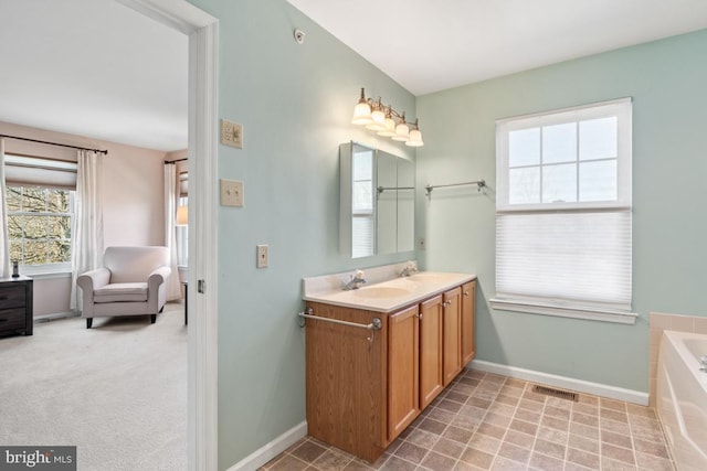 full bathroom featuring visible vents, baseboards, a bath, and vanity