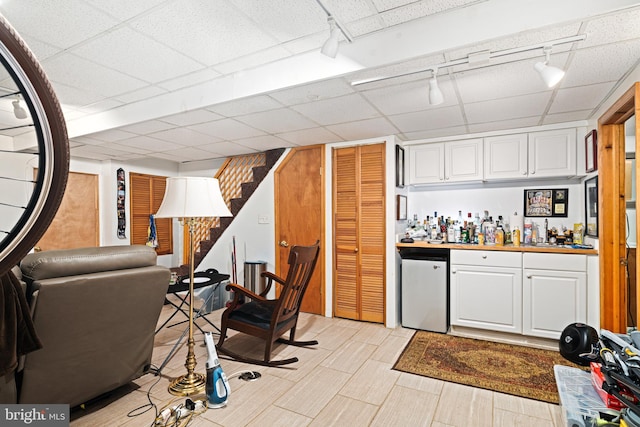 6476 Morris Park Rd, Philadelphia, PA 19151 - bar with track lighting, refrigerator, a bar, and stairs