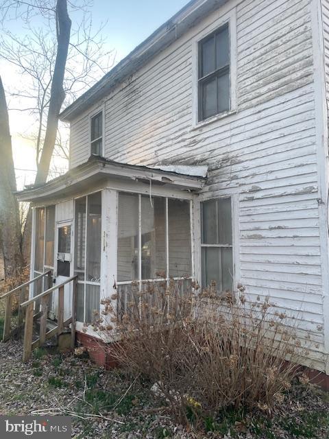 view of property exterior featuring a sunroom