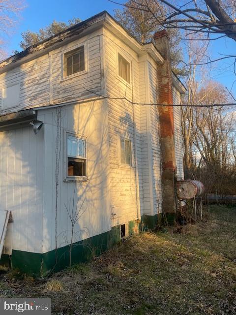 view of property exterior featuring a chimney