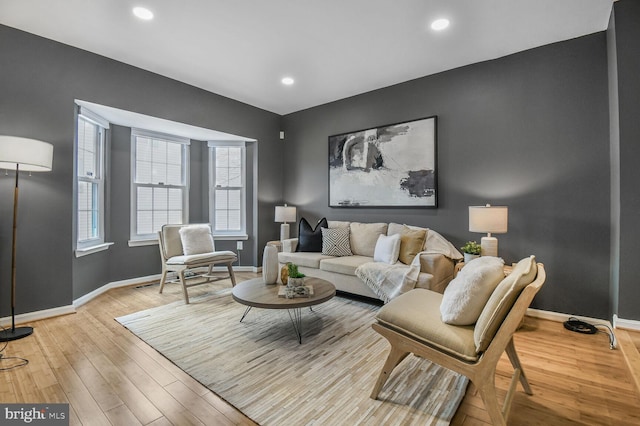 living room featuring recessed lighting, baseboards, and light wood-style floors