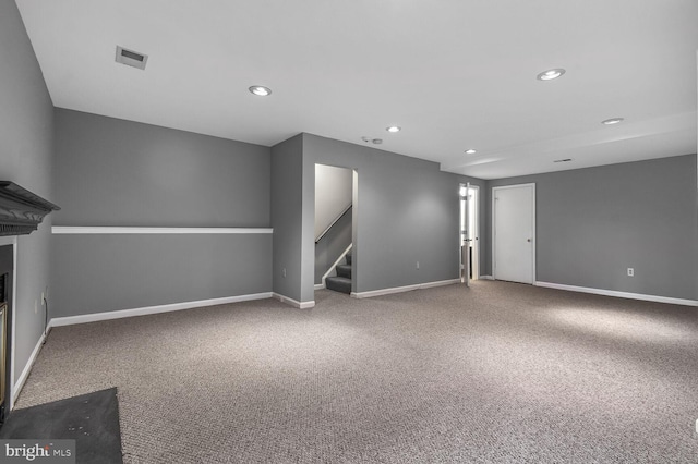 interior space with stairway, baseboards, carpet, and visible vents