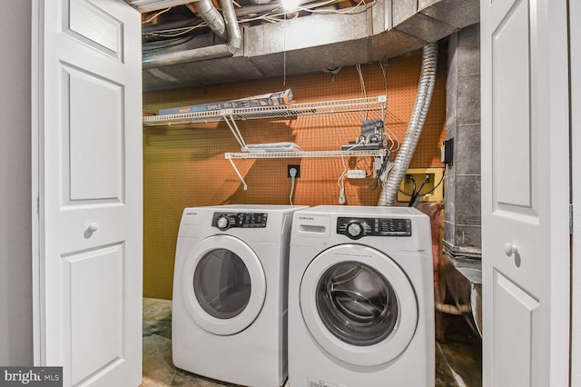 washroom with washing machine and dryer and laundry area