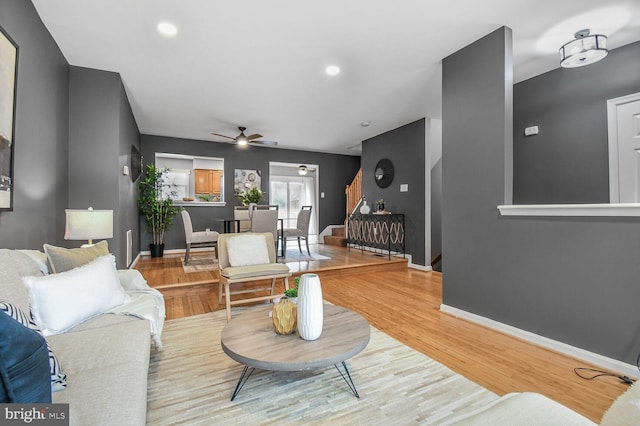 living room featuring recessed lighting, baseboards, a ceiling fan, and wood finished floors