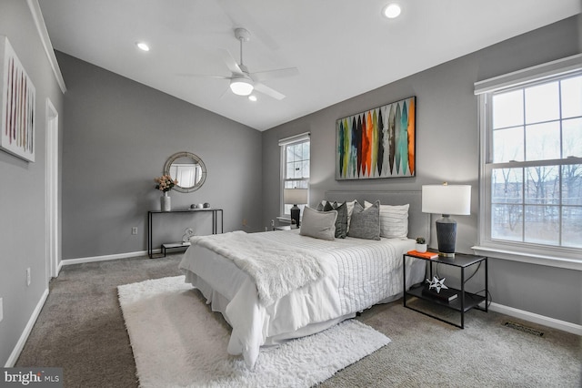 bedroom featuring visible vents, baseboards, lofted ceiling, and carpet floors