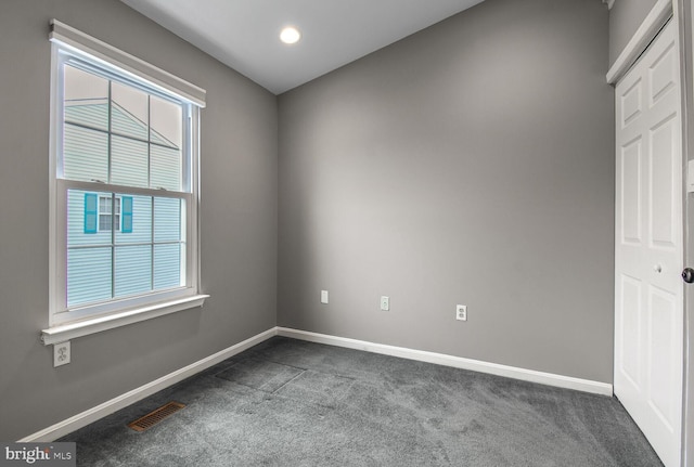 unfurnished room featuring recessed lighting, baseboards, visible vents, and dark carpet