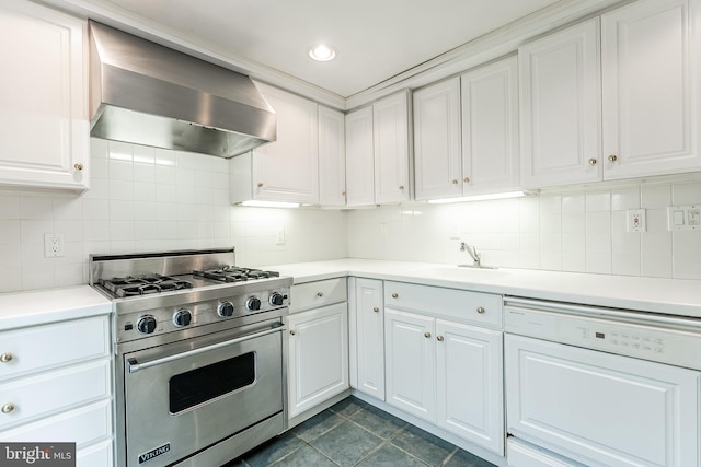 kitchen featuring wall chimney exhaust hood, backsplash, a sink, premium range, and dishwashing machine