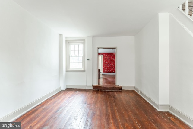 unfurnished room with baseboards and hardwood / wood-style floors