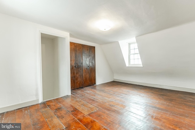 bonus room with vaulted ceiling and hardwood / wood-style flooring