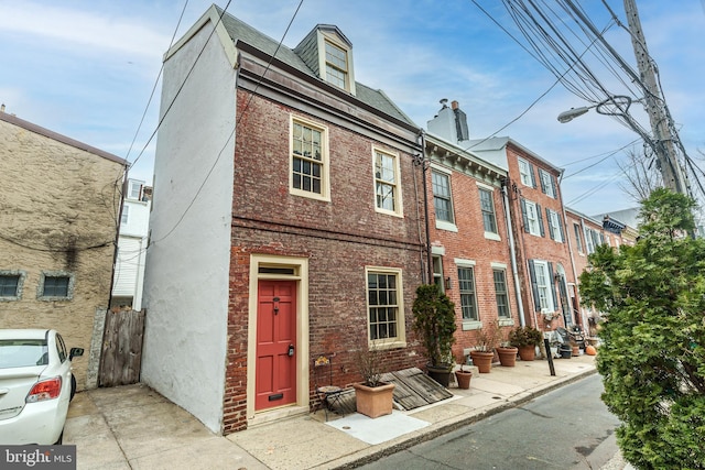 townhome / multi-family property with brick siding