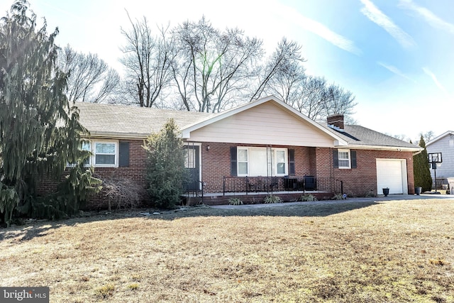 ranch-style home with a garage, brick siding, a chimney, and a front lawn