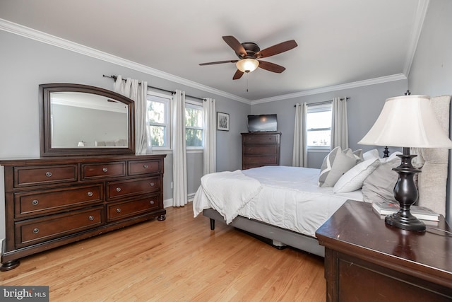 bedroom featuring a ceiling fan, crown molding, and light wood-style flooring