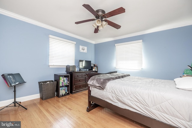 bedroom with ornamental molding, ceiling fan, light wood-style flooring, and baseboards