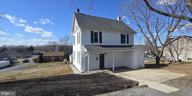 view of front of home featuring a residential view and roof with shingles