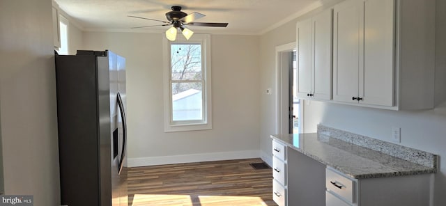 kitchen featuring ornamental molding, wood finished floors, baseboards, and stainless steel fridge with ice dispenser