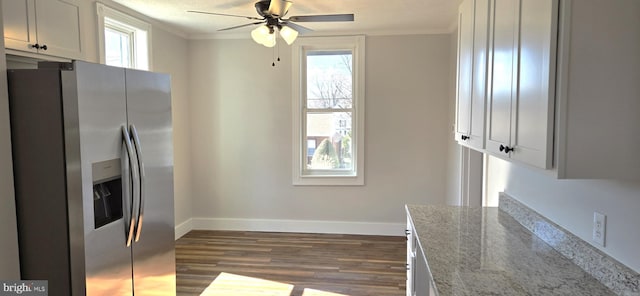 kitchen featuring plenty of natural light, dark wood-type flooring, stainless steel refrigerator with ice dispenser, and ornamental molding