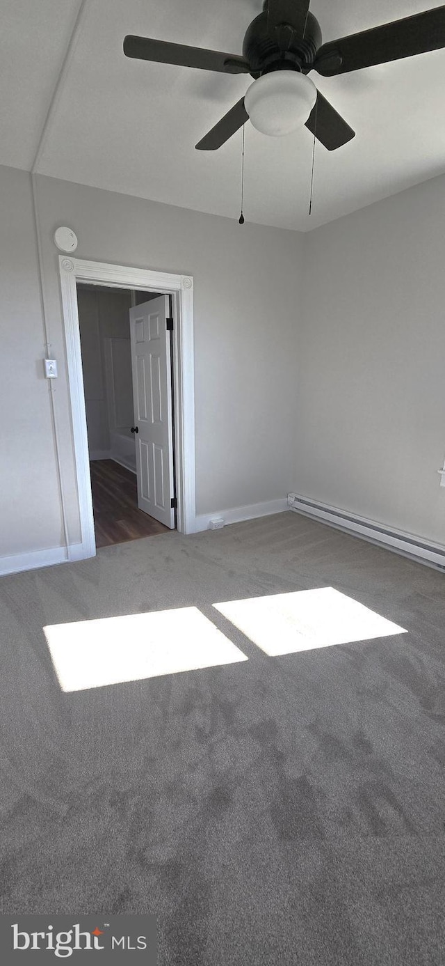 spare room featuring a baseboard radiator, carpet floors, baseboards, and ceiling fan